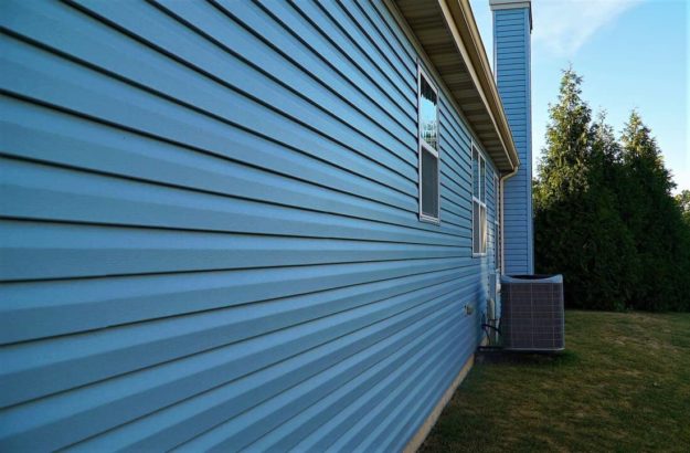 Blue siding and a radiator.