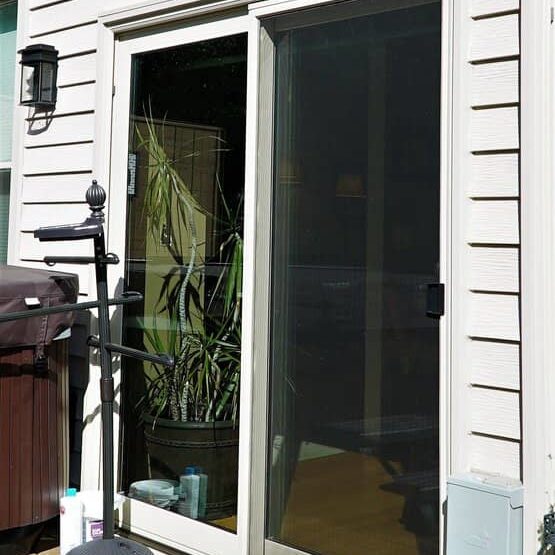 A white sliding door sits before a patio.