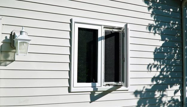 A white casement window is partially ajar.