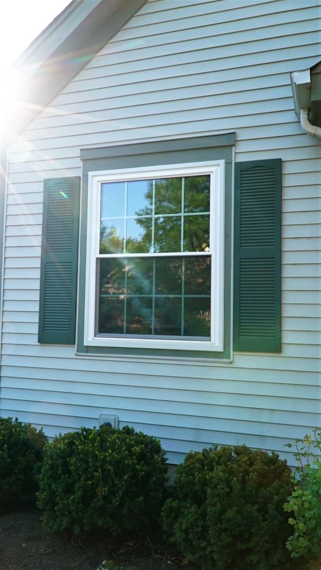 A single window has green shutters.