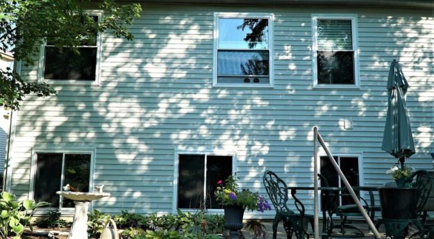 Several windows complement a white home.
