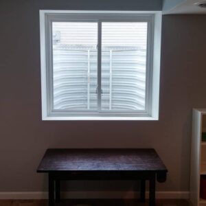 A basement window with a table in front of it
