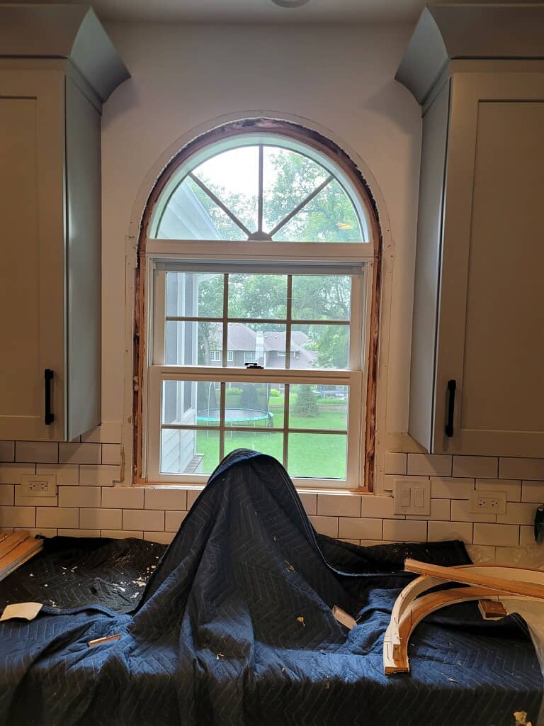 Tearing down a double hung window.