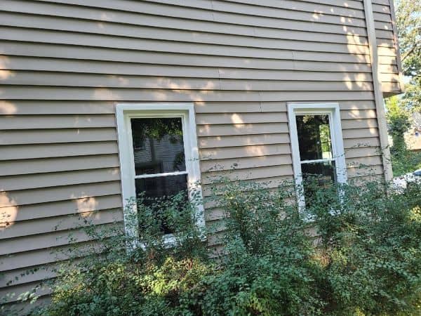 Two double hung windows installed on the side of a home