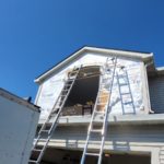 A house undergoes renovations for siding and windows.