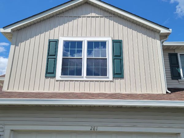 Green shutters decorate double hung windows.
