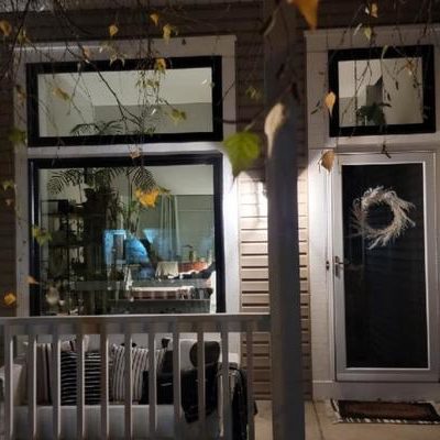 These picture windows complement a home's entryway at night.