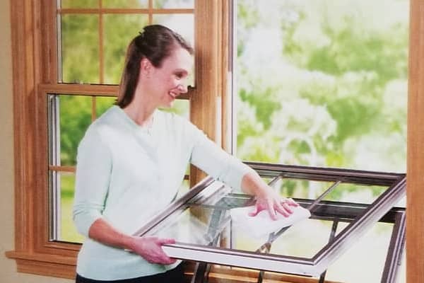 Woman cleaning her double hung windows