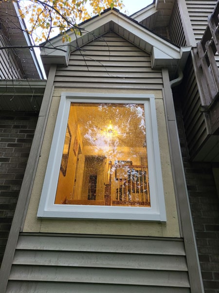 A picture window reveals indoor light.