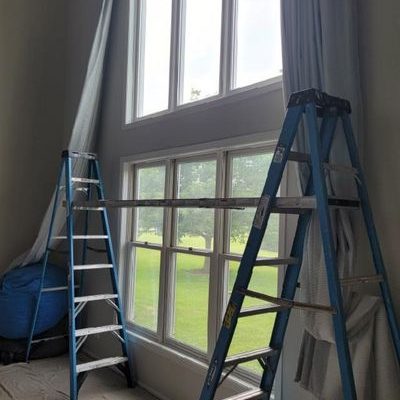 Ladders sit before a window prior to installation.