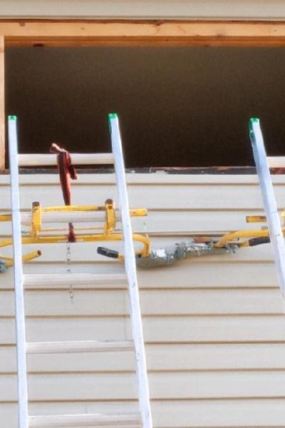 Ladders against an opening in a home