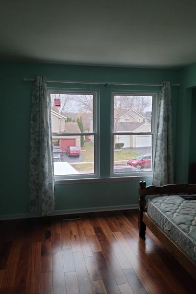 Two double hung windows in a bedroom