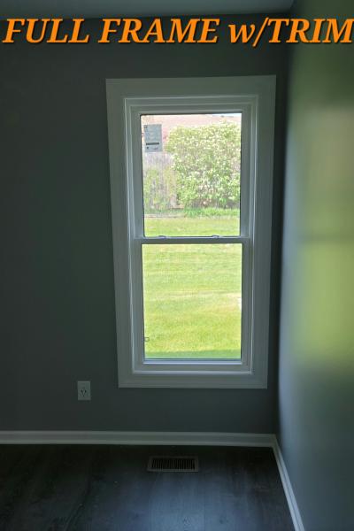 A tall double-hung window enjoys a full frame trim