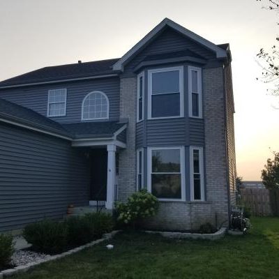 New windows grace a home as a sun sets over Lake in the Hills, IL
