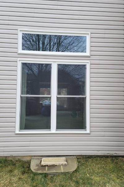 One picture window above two double hung windows