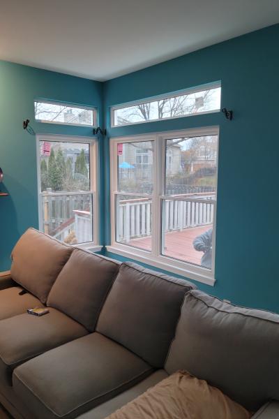 Corner windows in a turquoise room
