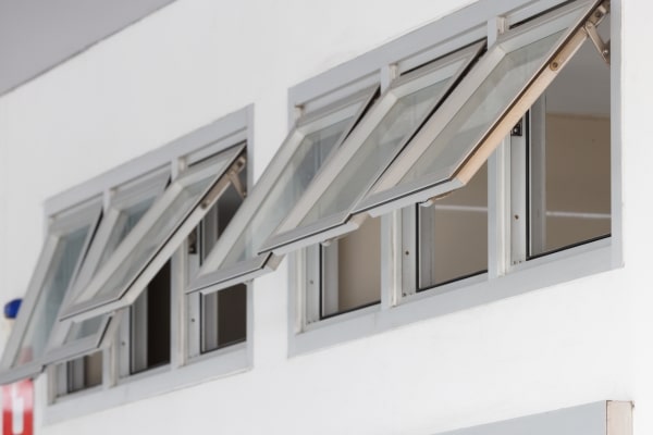 Row of open awning windows high on a wall