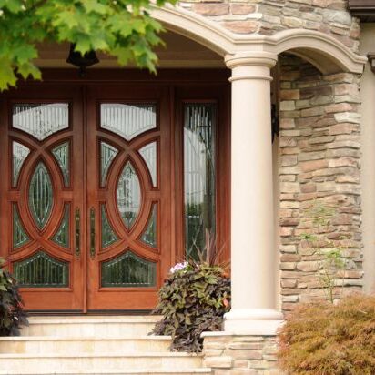 Entry doors with intricate designs and glass paneling