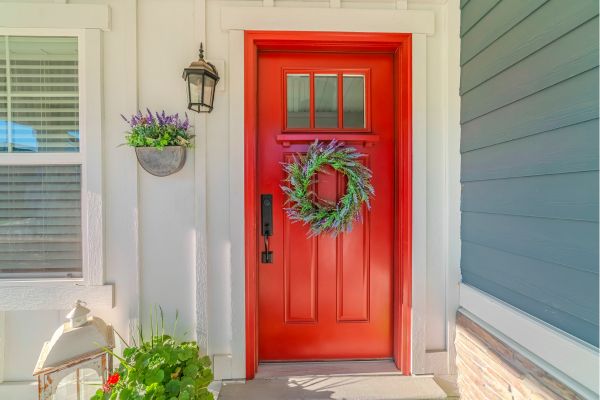 Bright red front door with wreath