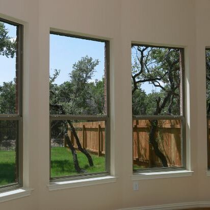 Window Replacement Cost A row of new windows looking out at a backyard