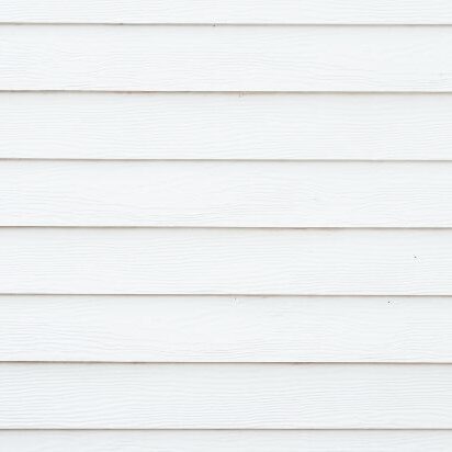 Siding Installation Guide Close-up of white siding that has already been installed on a home