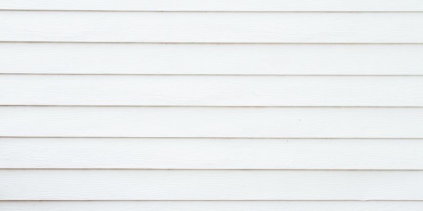 Close-up of white siding that has already been installed on a home