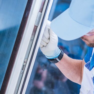 Window Installation By Contractor A contractor is installing a new window on a house